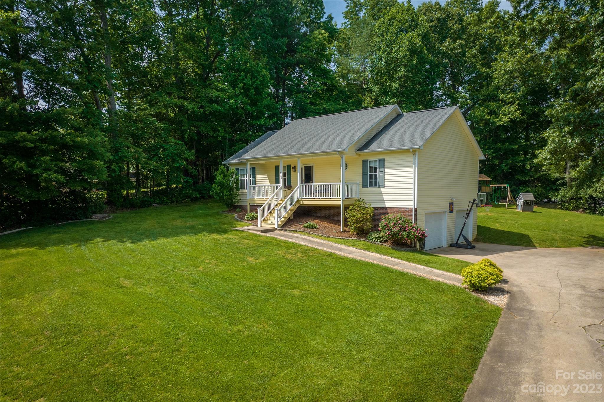 4331 Acorn Trace Morganton, NC 28655 - Photo 2 of 22 a view of a house with a patio and a yard