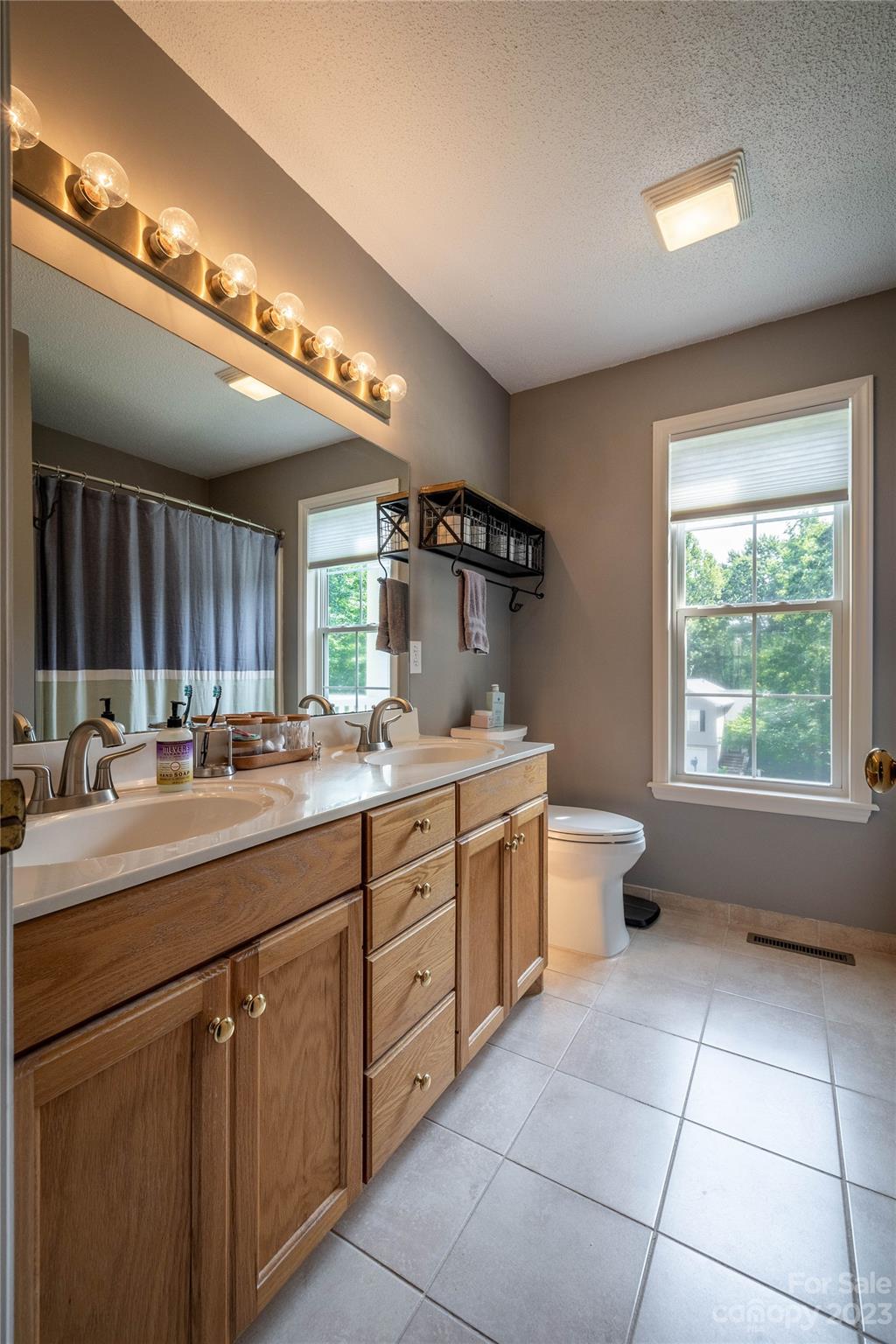 4331 Acorn Trace Morganton, NC 28655 - Photo 10 of 22 a bathroom with a granite countertop sink a toilet and a mirror