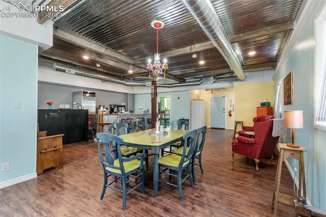 a view of a dining room with furniture window and wooden floor