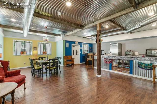 a dining room with furniture wooden floor and a rug