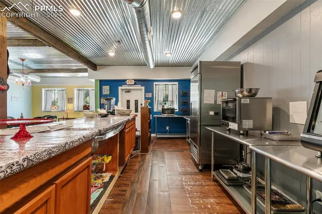 a kitchen with stainless steel appliances granite countertop sink stove and refrigerator