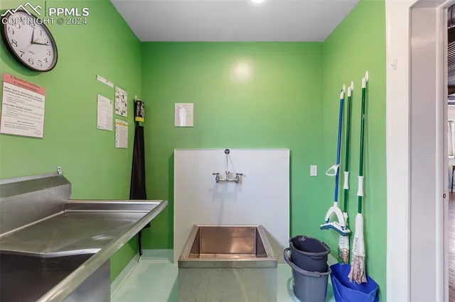 a bathroom with a granite countertop bathtub sink and toilet