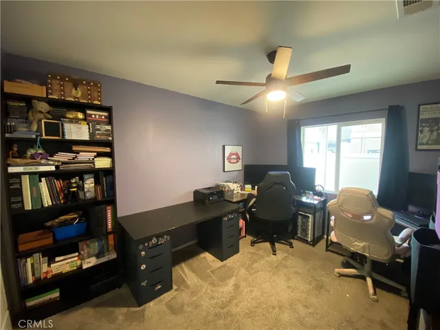 a livingroom with workspace and a window