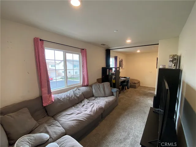 a living room with furniture window and a flat screen tv