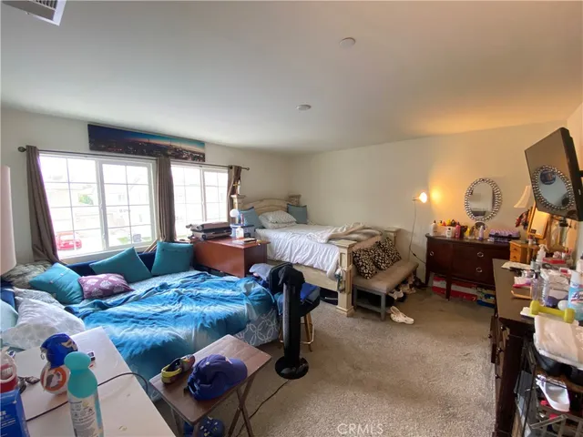 a bedroom with furniture and a window