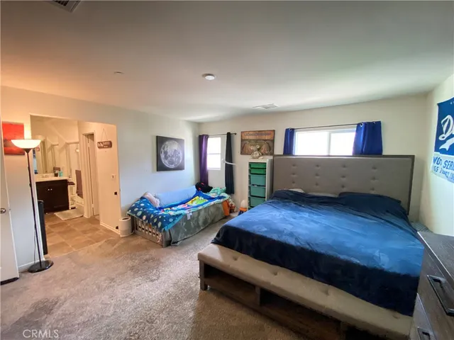 a living room with furniture and a dresser