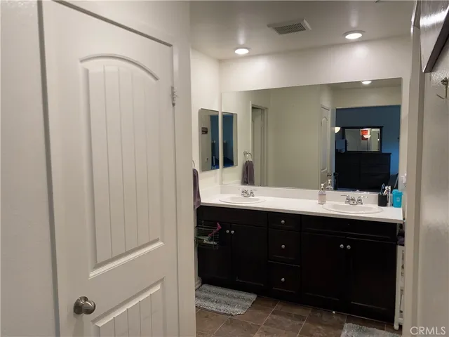 a bathroom with a double vanity sink and mirror