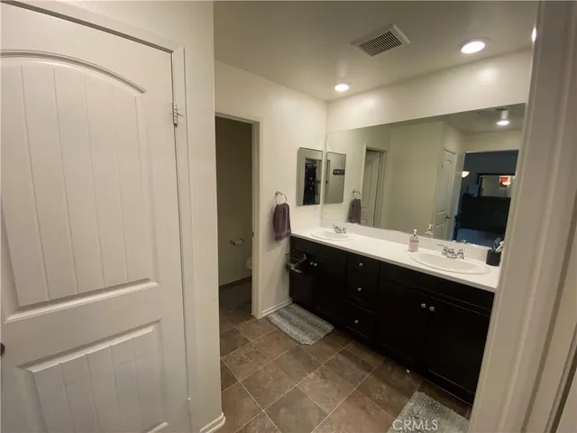 a bathroom with a double vanity sink and mirror