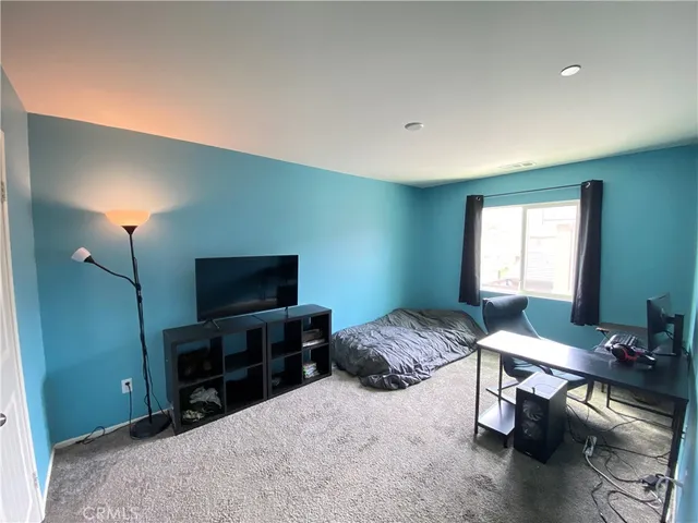 a bedroom with a bed and a television