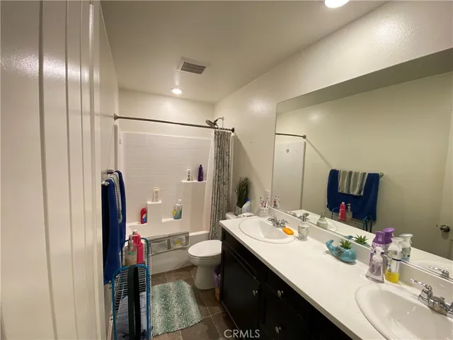 a bathroom with a sink double vanity and a mirror