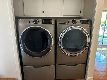 a view of a storage and utility room with washer and dryer