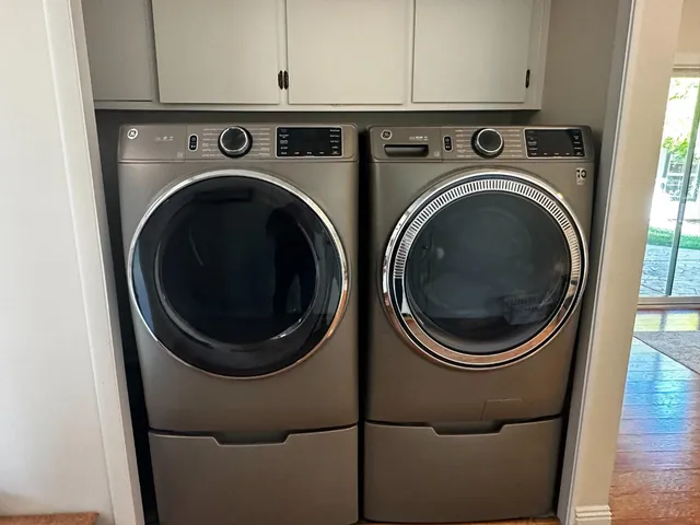 a view of a storage and utility room with washer and dryer
