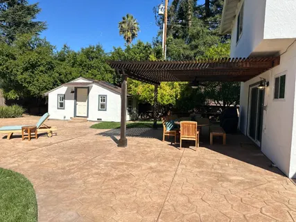 a view of a chairs and table in the patio and a fountain