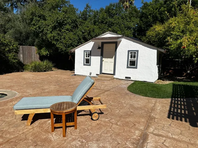 a swimming pool with outdoor seating and garden