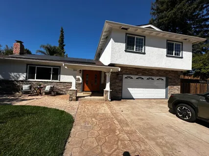 a view of a house with outdoor space and sitting area