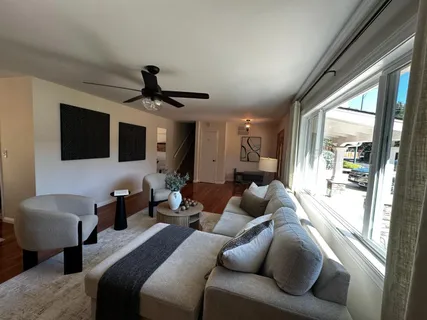a living room with furniture and a large window