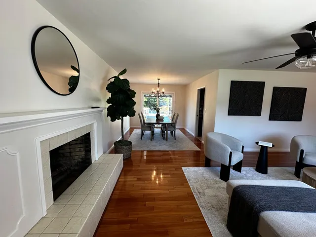 a living room with furniture a mirror and a fireplace