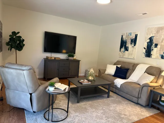 a living room with furniture and a flat screen tv