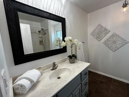 a bathroom with a sink vanity and mirror