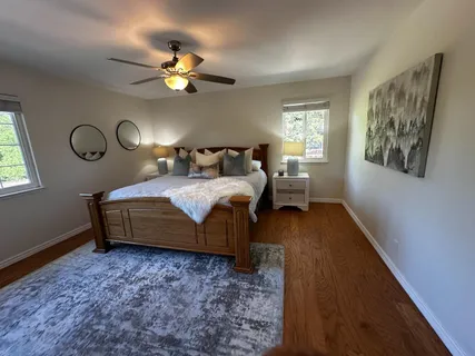 a bedroom with a bed mirror and a window