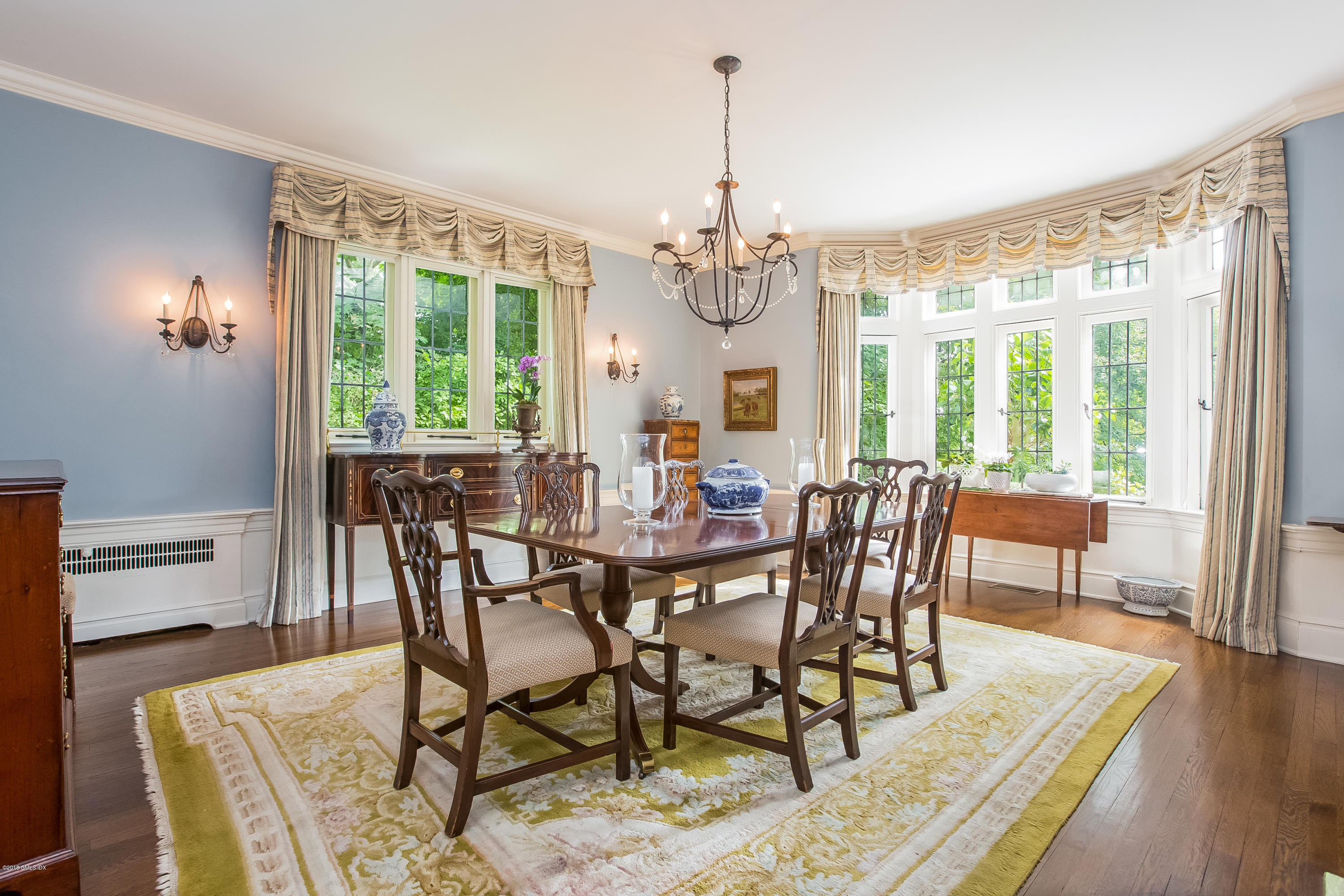 293 Shore Road Greenwich, CT 06830 - Photo 8 of 31 a view of a dining room with furniture window and wooden floor