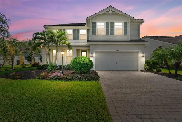 a front view of a house with a yard and garage
