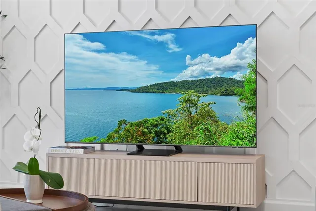 a kitchen with kitchen island granite countertop a sink cabinets and wooden floor
