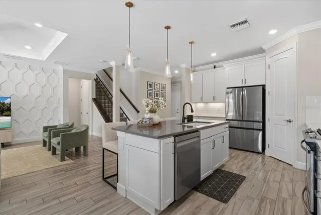 a kitchen with cabinets and stainless steel appliances