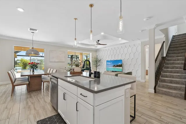 a kitchen with granite countertop white cabinets and stainless steel appliances