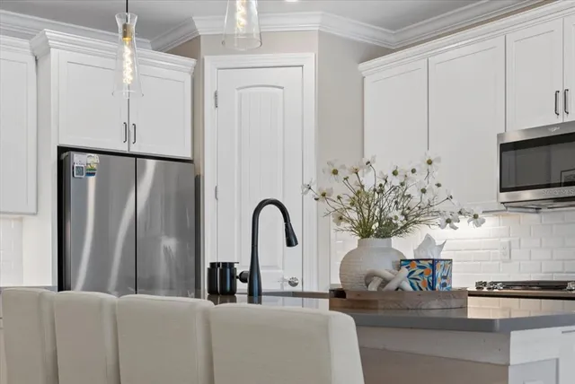 a bedroom with a large bed and a potted plant