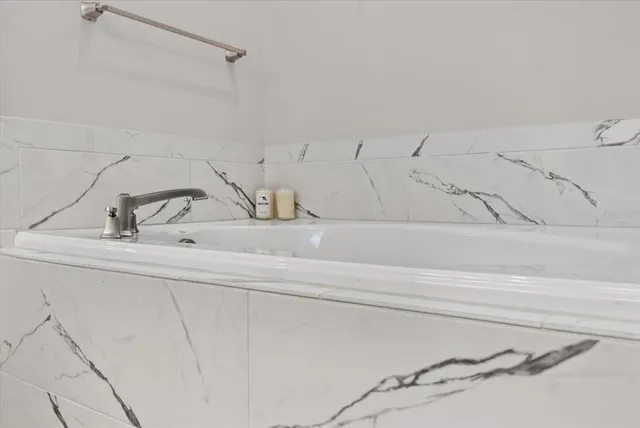 a spacious bedroom with a bed and a window