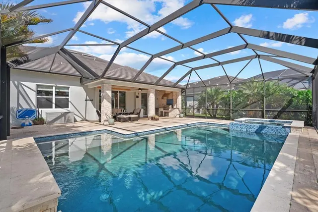 a view of a swimming pool with lawn chairs under an umbrella
