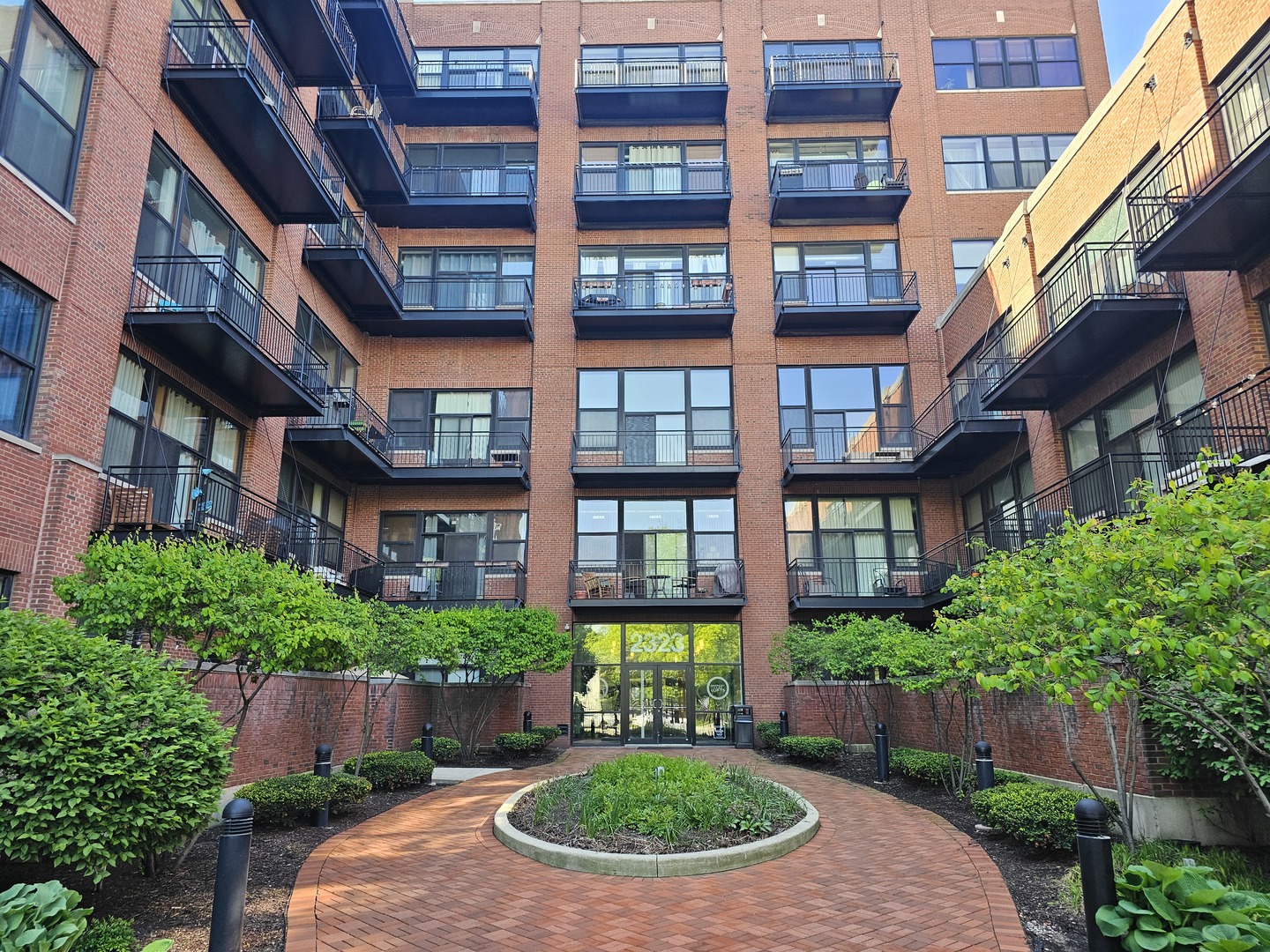 2323 West Pershing Road, Unit 230 Chicago, IL 60609 - Photo 4 of 30 a view of a brick building next to a yard