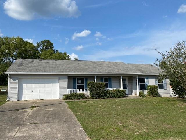 7023 Hemlock Road Ocala, FL 34472 - Photo 1 of 1 a front view of a house with a garden