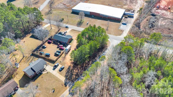 an aerial view of a house a yard and mountain view in back
