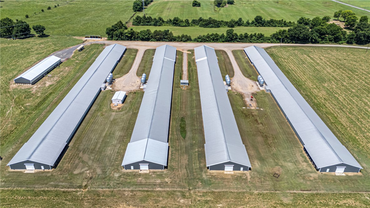 276 Charton Road Morrilton, AR 72110 - Photo 1 of 37 Expansive agricultural complex featuring five primary structures with metal roofs and a smaller ancillary building