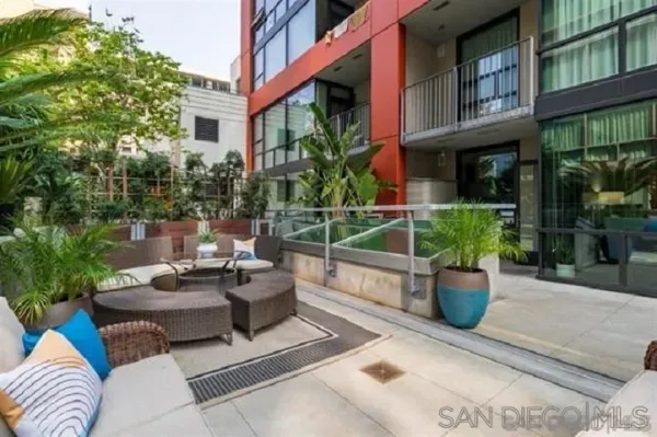 a view of a patio with couches and potted plants