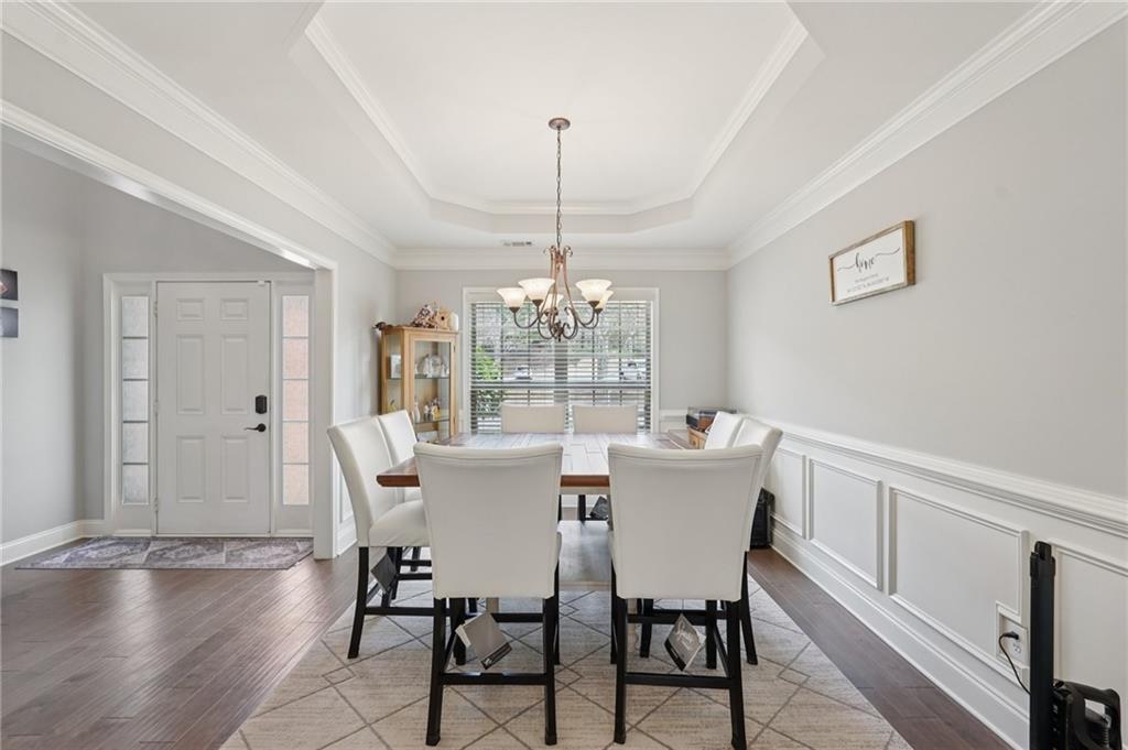 1330 Primrose Park Road Sugar Hill, GA 30518 - Photo 11 of 76 a dining room with furniture window and wooden floor