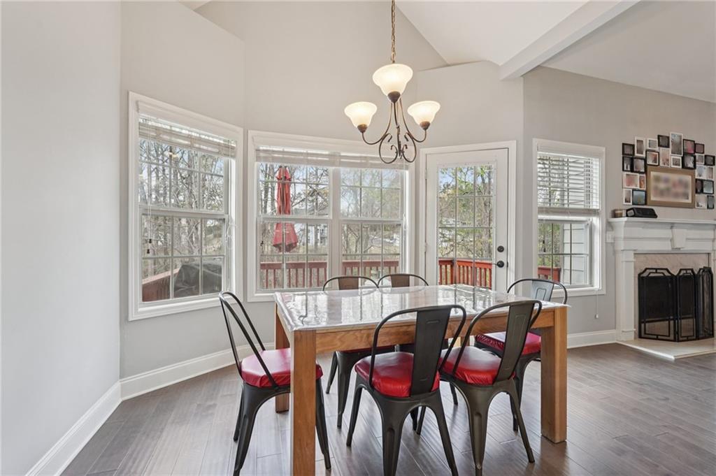 1330 Primrose Park Road Sugar Hill, GA 30518 - Photo 14 of 76 a view of a dining room with furniture wooden floor and chandelier