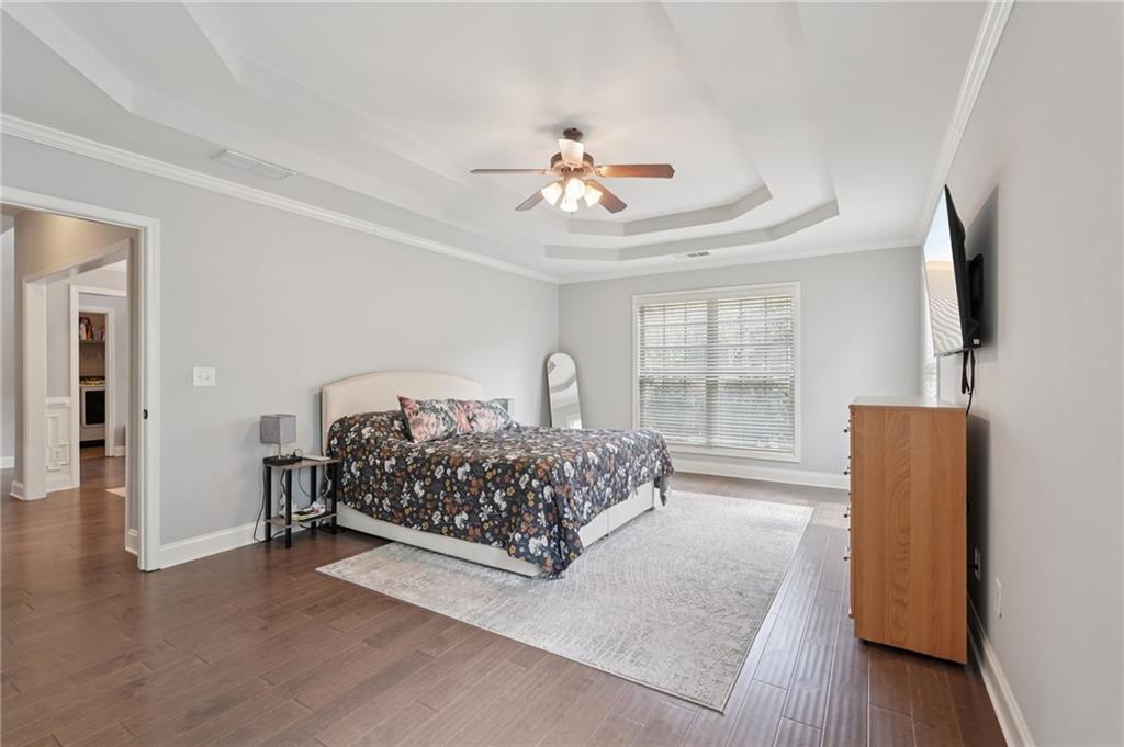 1330 Primrose Park Road Sugar Hill, GA 30518 - Photo 22 of 76 a bedroom with a bed and a flat tv screen on dresser