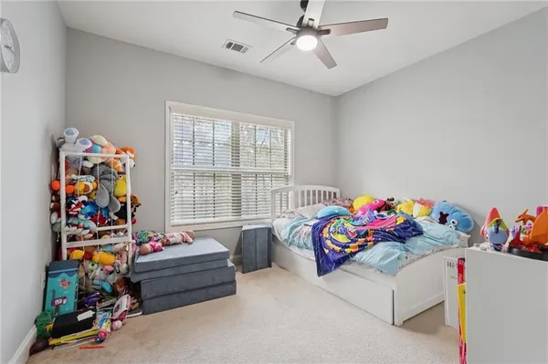 a living room with furniture and a ceiling fan