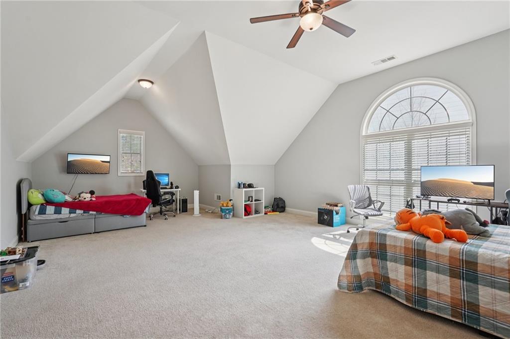 1330 Primrose Park Road Sugar Hill, GA 30518 - Photo 26 of 76 a bedroom with furniture and a chandelier