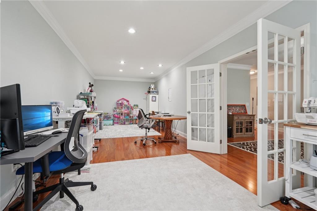 1330 Primrose Park Road Sugar Hill, GA 30518 - Photo 29 of 76 a living room with furniture a flat screen tv and a refrigerator