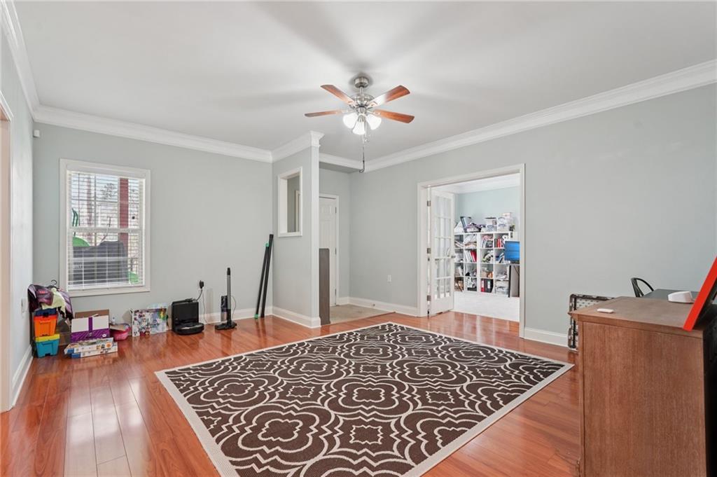 1330 Primrose Park Road Sugar Hill, GA 30518 - Photo 30 of 76 a living room with furniture and wooden floor