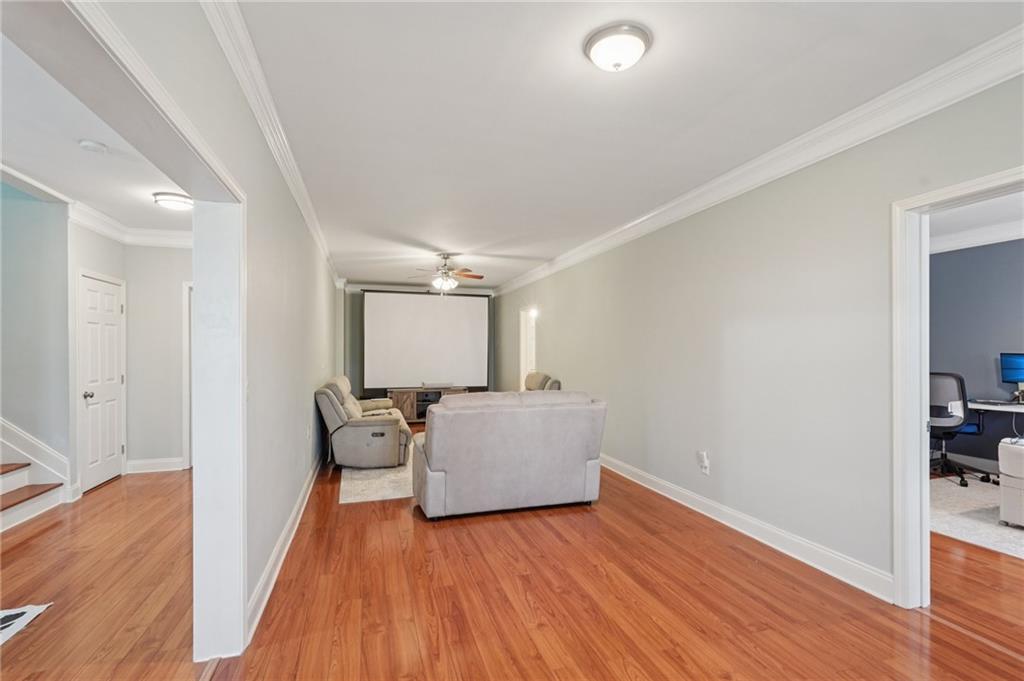 1330 Primrose Park Road Sugar Hill, GA 30518 - Photo 32 of 76 a room with furniture and wooden floor