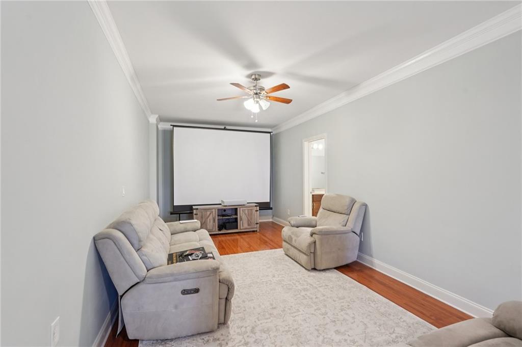 1330 Primrose Park Road Sugar Hill, GA 30518 - Photo 33 of 76 a living room with furniture and a ceiling fan