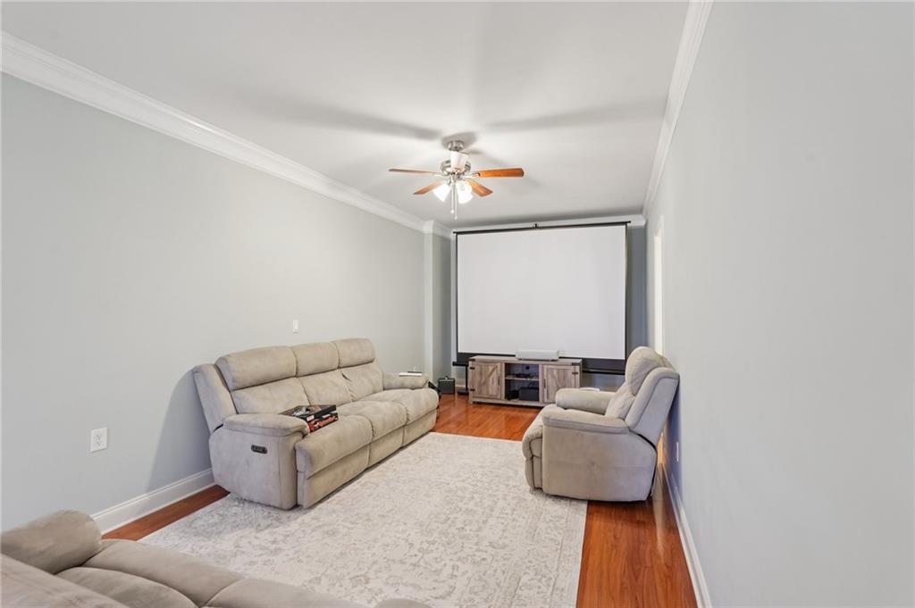 1330 Primrose Park Road Sugar Hill, GA 30518 - Photo 34 of 76 a living room with furniture and a ceiling fan