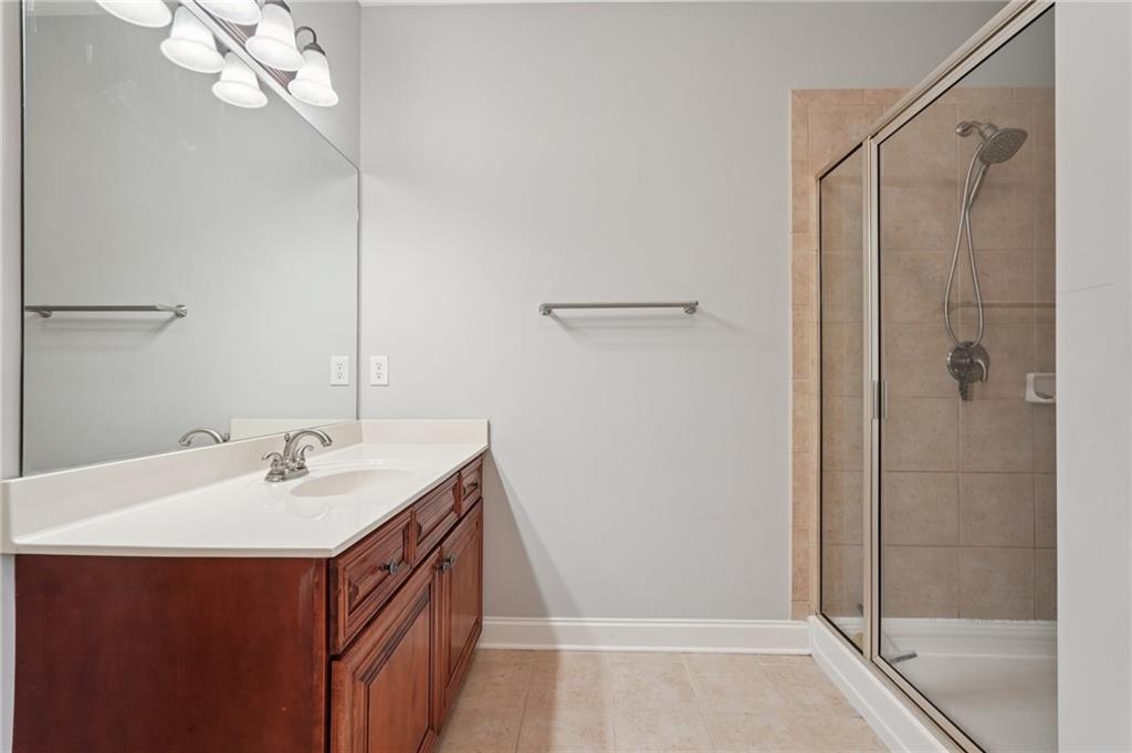1330 Primrose Park Road Sugar Hill, GA 30518 - Photo 40 of 76 a bathroom with a sink a mirror and a shower