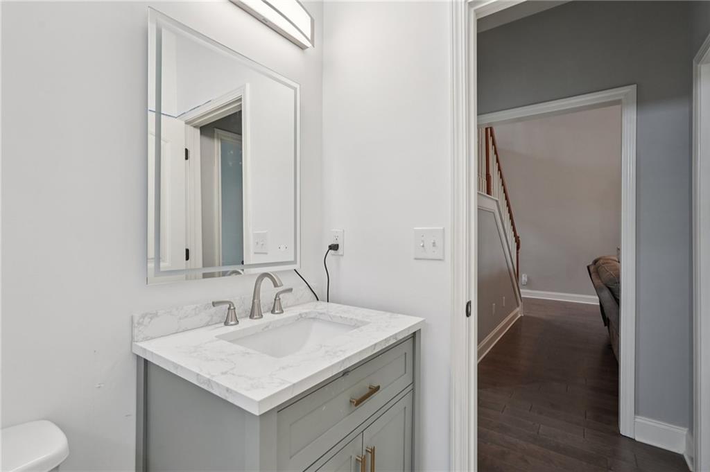 1330 Primrose Park Road Sugar Hill, GA 30518 - Photo 43 of 76 a bathroom with a sink toilet and mirror