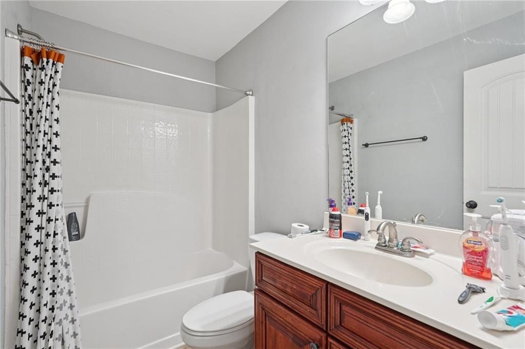 1330 Primrose Park Road Sugar Hill, GA 30518 - Photo 44 of 76 a bathroom with a sink a toilet and shower